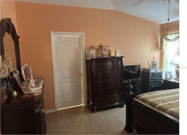 tiled bedroom with lofted ceiling and ceiling fan