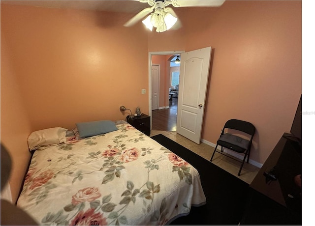 tiled bedroom with ceiling fan