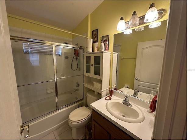 full bathroom featuring vanity, toilet, shower / bath combination with glass door, and tile patterned flooring