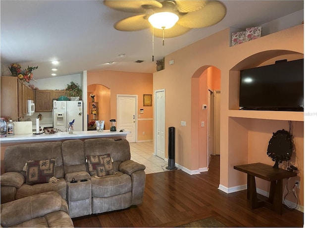 6812 Aramon Ct, Wesley Chapel, FL 33545 - living room featuring arched walkways, ceiling fan, light wood finished floors, lofted ceiling, and baseboards