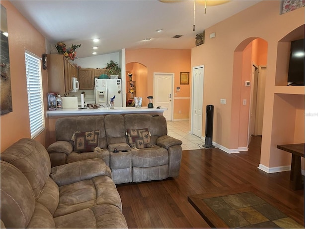 living room with vaulted ceiling and light hardwood / wood-style floors