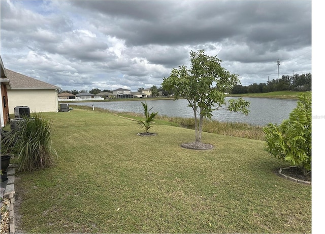 view of yard featuring a water view and central AC