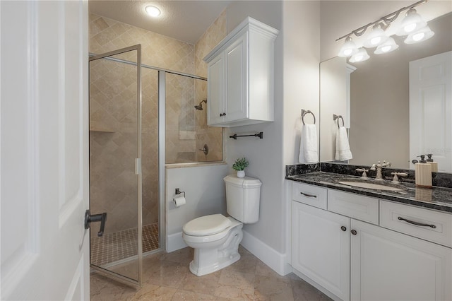 bathroom with toilet, a textured ceiling, walk in shower, and vanity