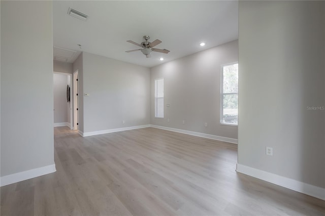 empty room featuring ceiling fan and light hardwood / wood-style flooring