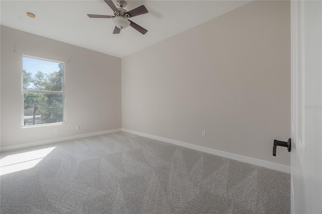 carpeted spare room featuring ceiling fan