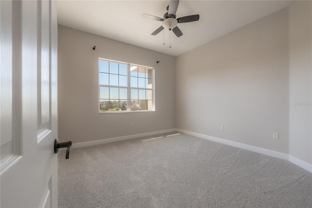 carpeted spare room with ceiling fan