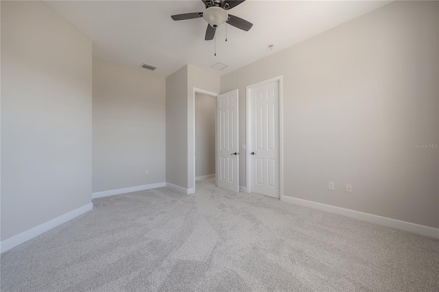 unfurnished bedroom featuring a closet, light colored carpet, and ceiling fan