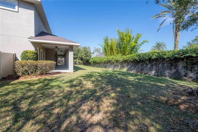 view of yard with ceiling fan