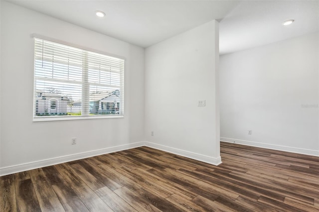 spare room with dark wood-type flooring