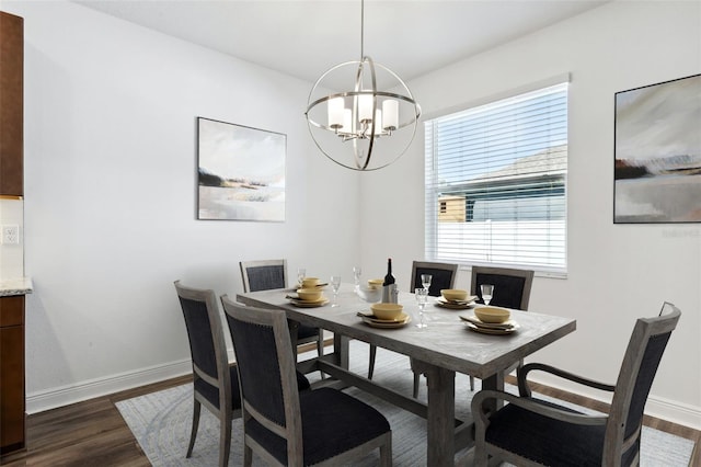 dining area with dark wood-type flooring and a chandelier