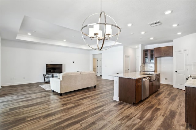 kitchen with dishwasher, a kitchen island with sink, dark hardwood / wood-style floors, hanging light fixtures, and dark brown cabinetry