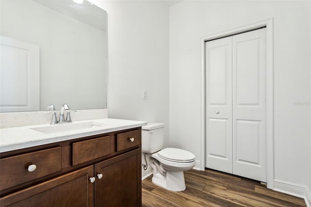 bathroom with vanity, hardwood / wood-style floors, and toilet