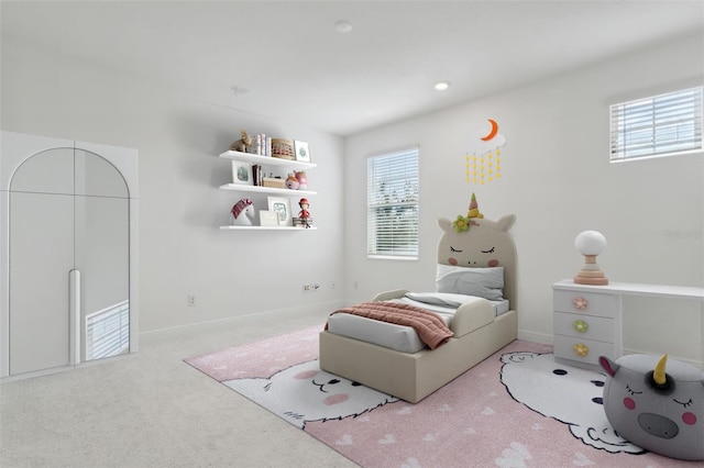 carpeted bedroom featuring multiple windows