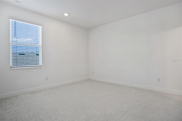 unfurnished room with light colored carpet