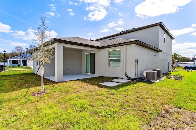 back of property featuring a yard, a patio area, and central air condition unit