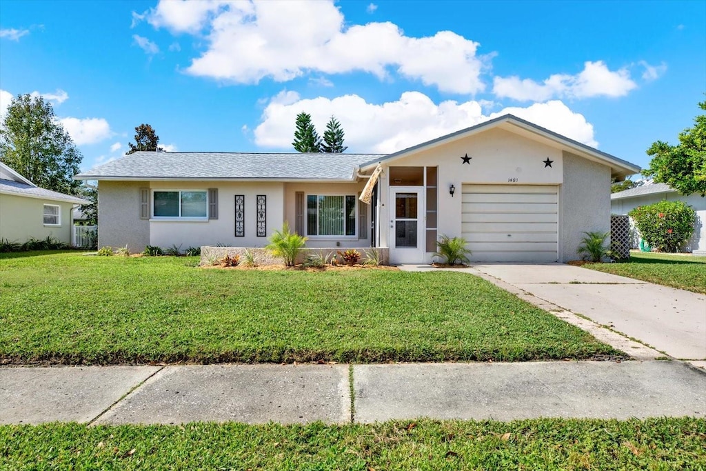 ranch-style house with a front yard and a garage