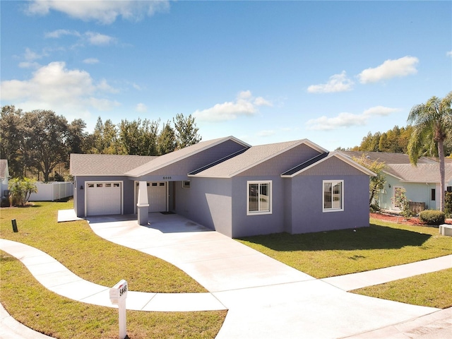 single story home with concrete driveway, stucco siding, fence, a front lawn, and a garage