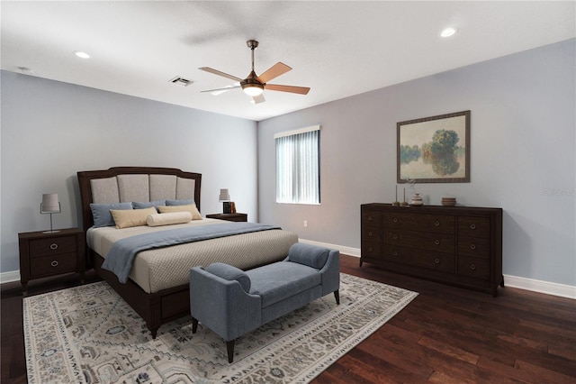 bedroom with dark hardwood / wood-style flooring and ceiling fan