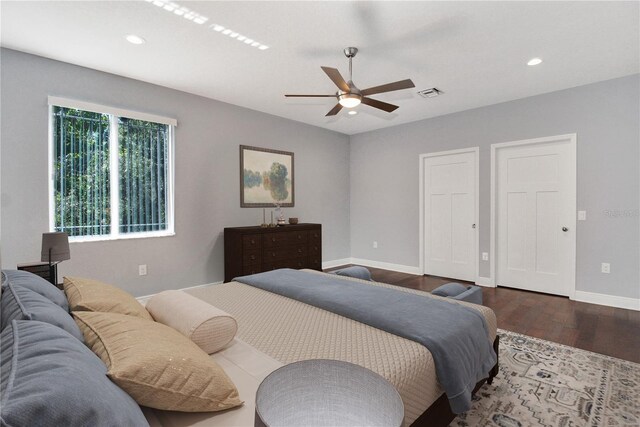 bedroom with ceiling fan and dark hardwood / wood-style flooring