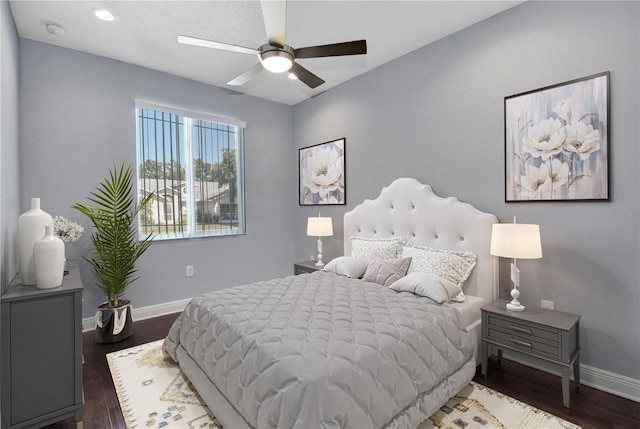 bedroom with dark hardwood / wood-style floors and ceiling fan