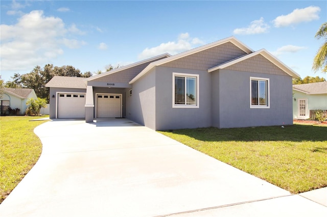 view of front of property featuring a front lawn and a garage