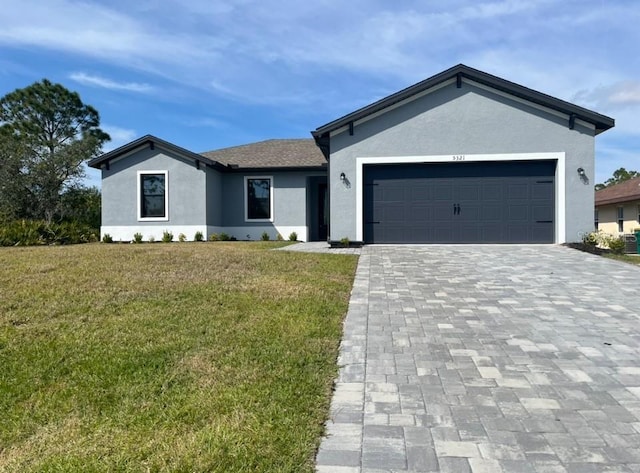 ranch-style house featuring a garage and a front lawn