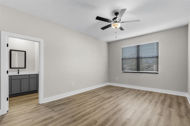 unfurnished room featuring ceiling fan, sink, and light hardwood / wood-style floors