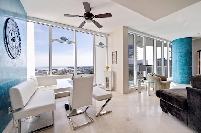 interior space featuring expansive windows, a healthy amount of sunlight, and ceiling fan