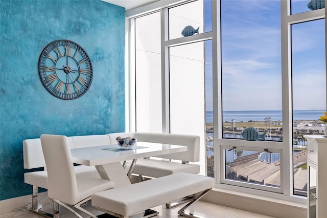 dining space featuring a water view and plenty of natural light