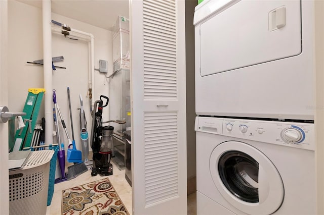 clothes washing area featuring stacked washer / drying machine