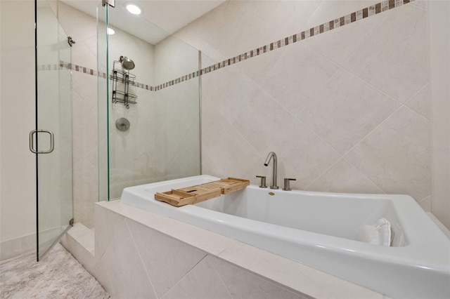 bathroom featuring shower with separate bathtub