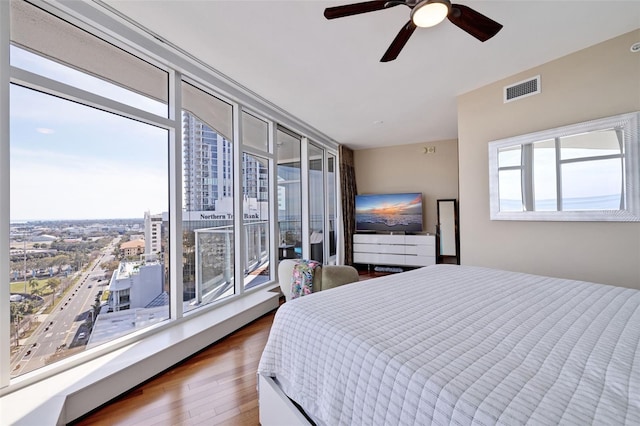 bedroom featuring ceiling fan, hardwood / wood-style flooring, and access to exterior