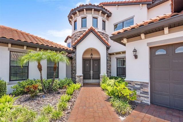 view of exterior entry with a garage