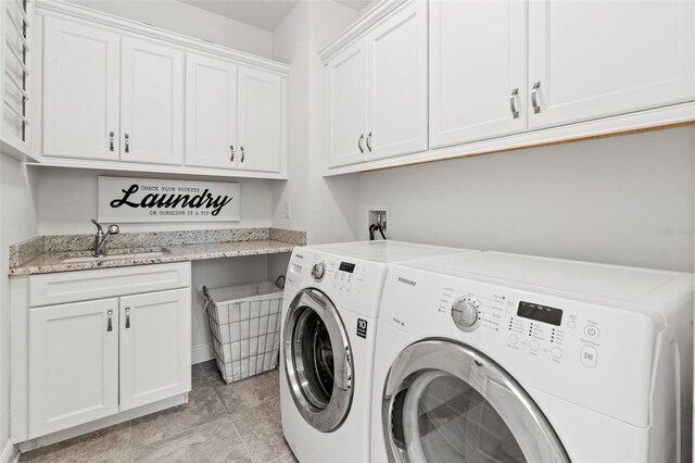 laundry room with light tile patterned floors, sink, separate washer and dryer, and cabinets