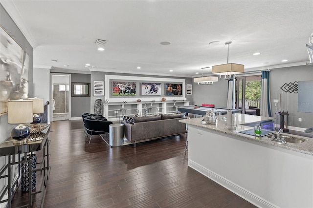 living room with ornamental molding, sink, and dark hardwood / wood-style floors