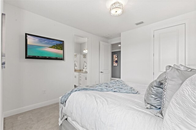 carpeted bedroom with ensuite bath