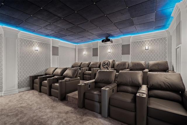 carpeted home theater room with crown molding