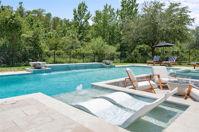 view of pool with a patio, pool water feature, and an in ground hot tub