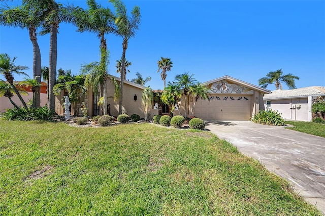 view of front of property with a front yard and a garage