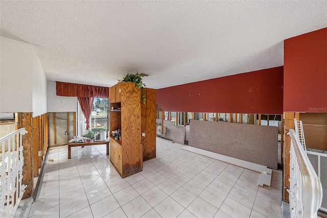 unfurnished room featuring a textured ceiling