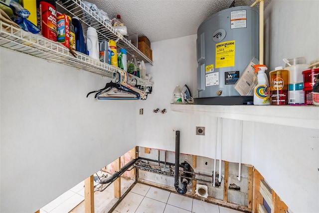 laundry room featuring a textured ceiling, electric water heater, and electric dryer hookup