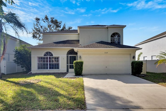 view of front of property featuring a front yard and a garage