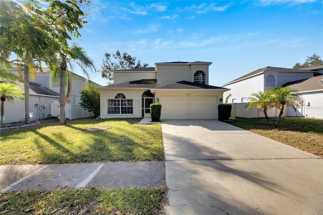 view of front of property featuring a front lawn and a garage