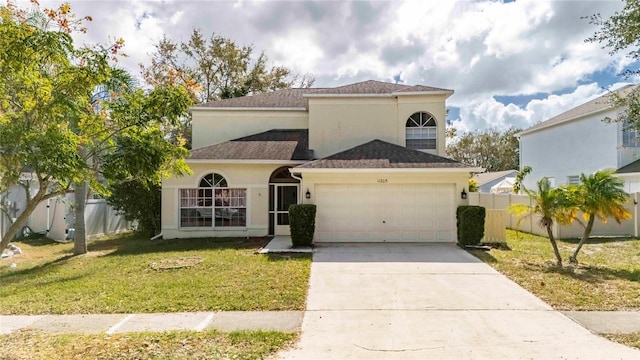 mediterranean / spanish-style house with a front yard and a garage