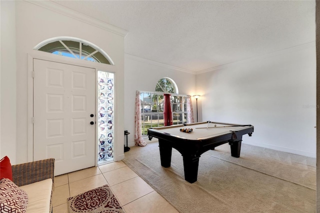 rec room with crown molding, pool table, a textured ceiling, and light tile patterned floors