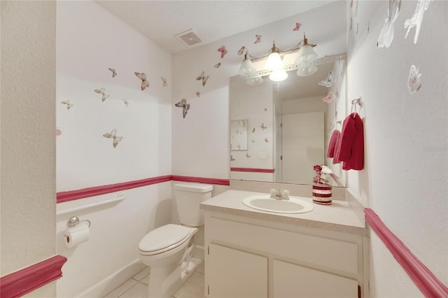 bathroom with vanity, toilet, and tile patterned floors