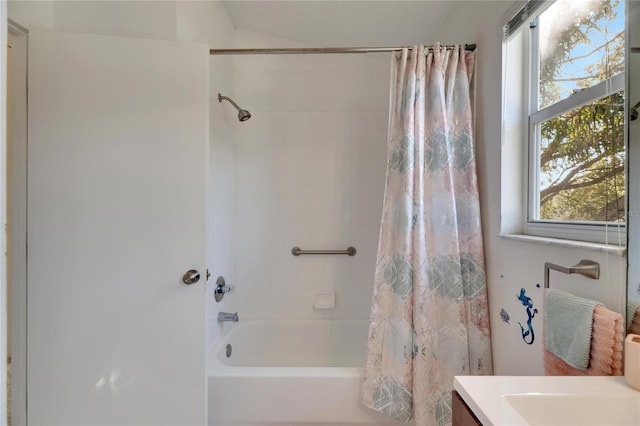 bathroom featuring vanity and shower / bathtub combination with curtain