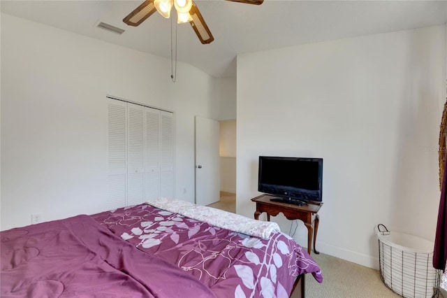 carpeted bedroom featuring a closet and ceiling fan