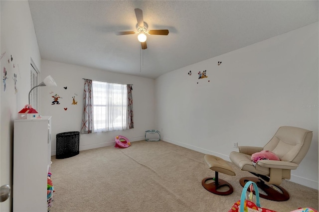 rec room with light carpet, a textured ceiling, and ceiling fan