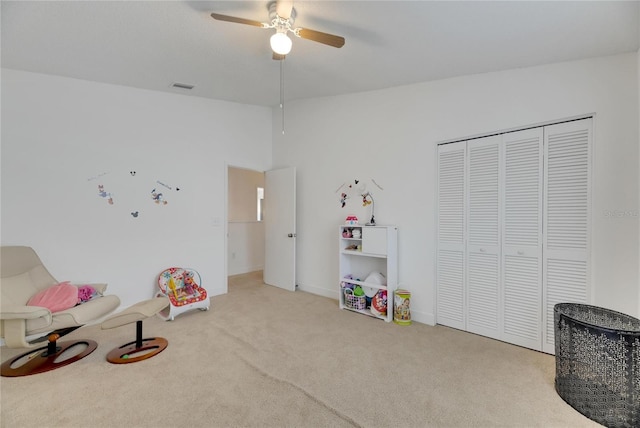 rec room featuring light colored carpet and ceiling fan